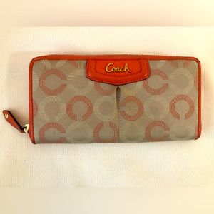 Large orange Coach wallet with zipper